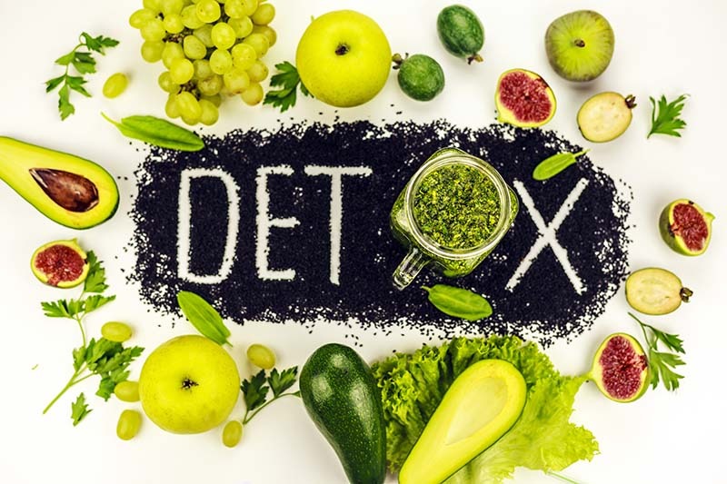 Concept of diet, word detox is made from black cumin seeds. Gree
